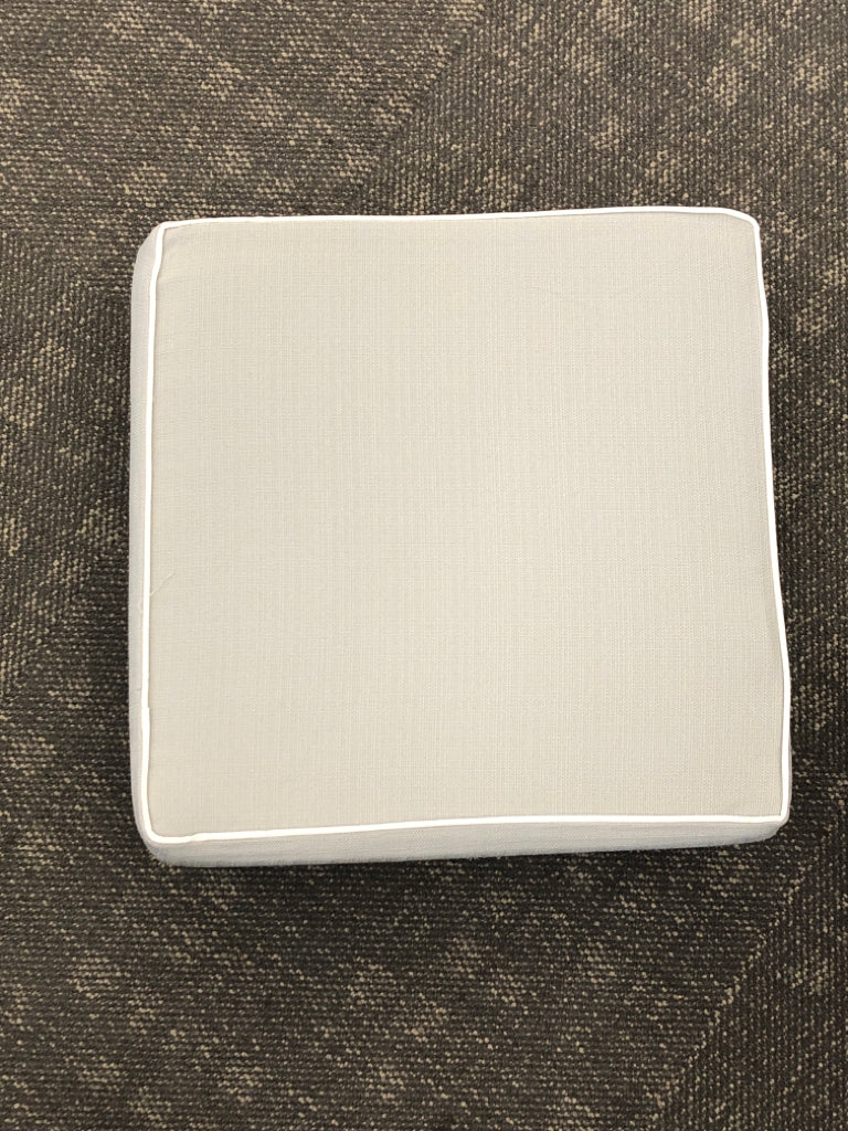 GRAY SEAT CUSHION W/WHITE TRIM.