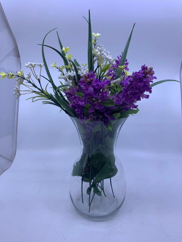 FAUX LAVENDER W/ YELLOW AND WHITE FLOWERS IN GLASS VASE.