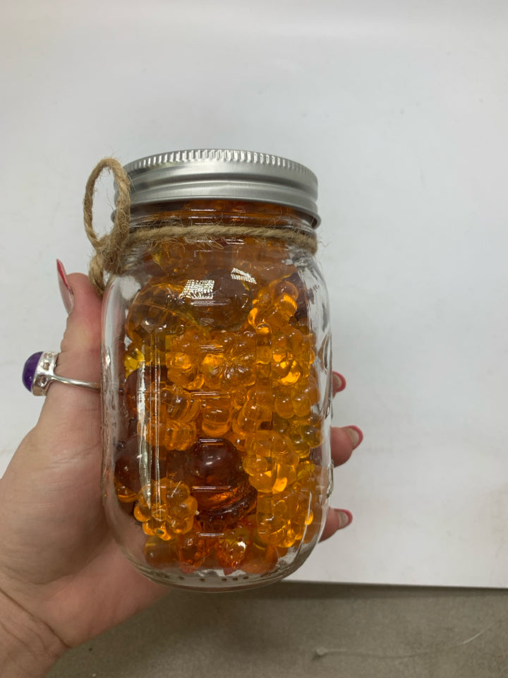 JAR OF PUMPKIN BEADS.