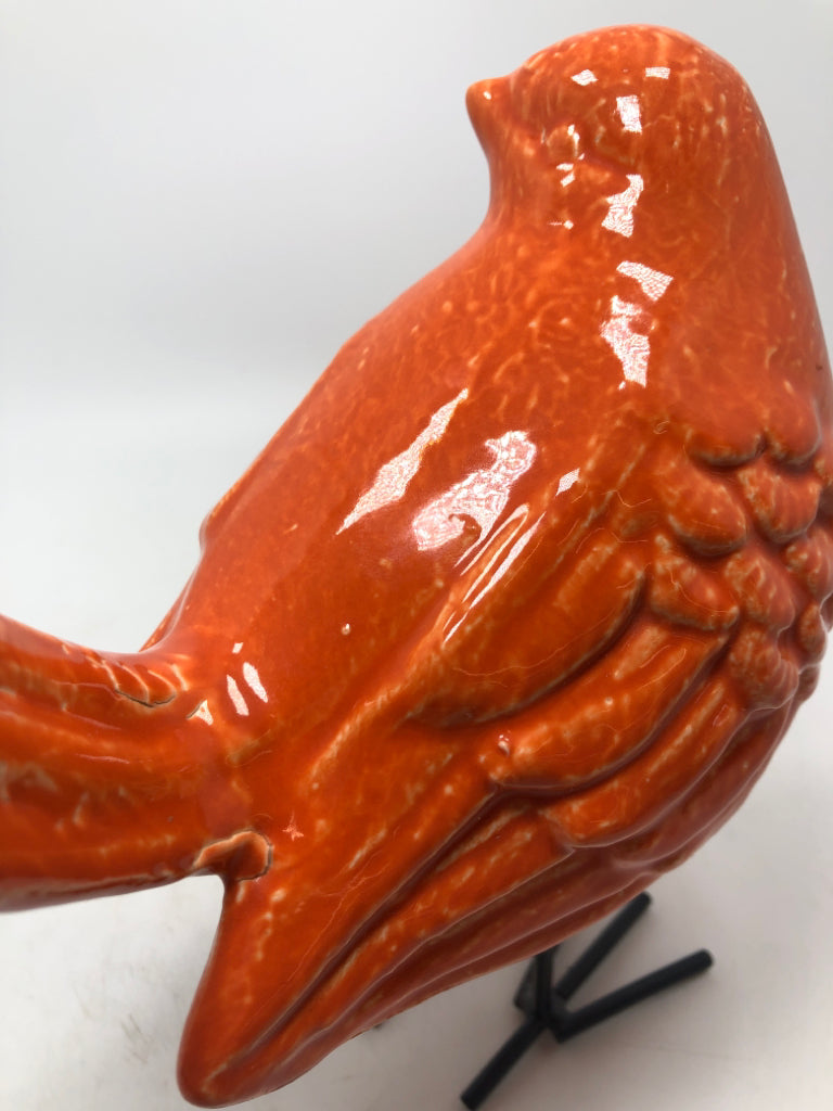 ORANGE CERAMIC BIRD W/METAL LEGS.