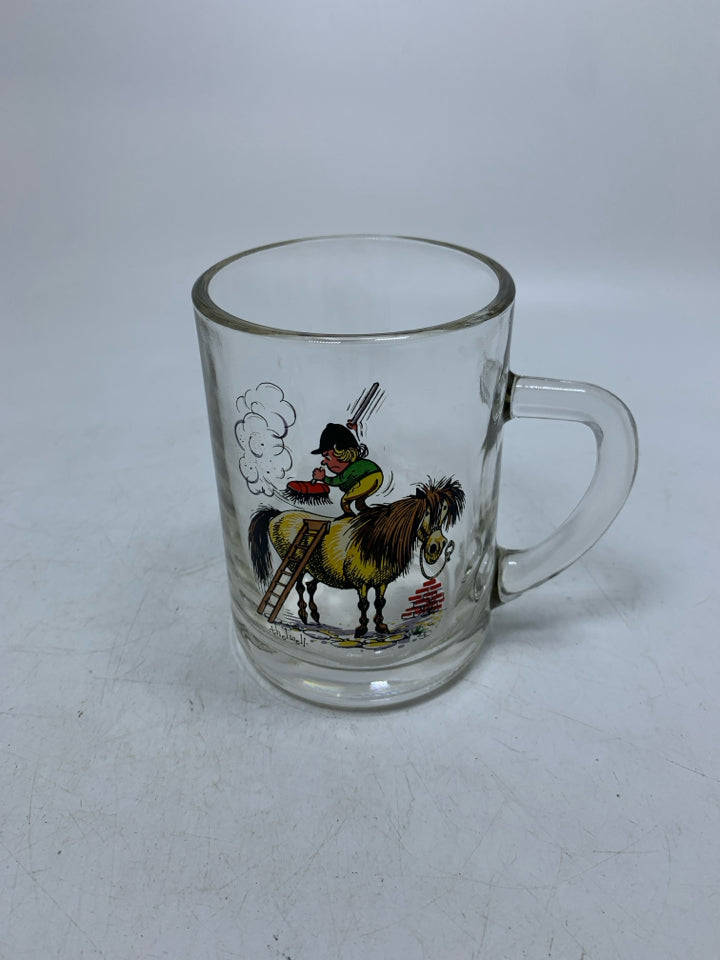 CLEAR GLASS MUG W/ PRINTED MAN ON HORSE BRUSHING IT OFF.