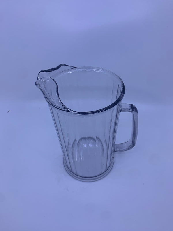 CLEAR RIBBED PLASTIC PITCHER.