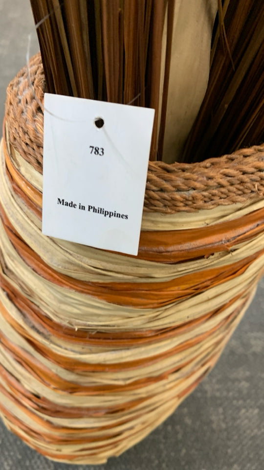 FAUX GRASS IN LARGE WOVEN BASKET VASE.