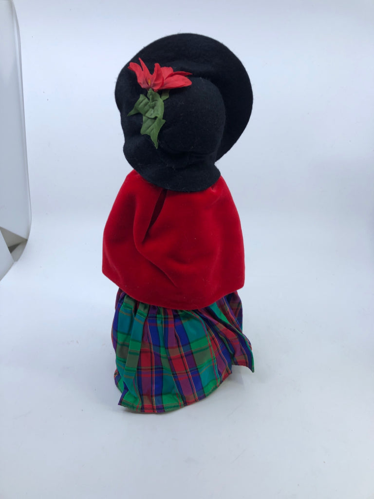 BYERS' CHOICE WOMAN IN RED COAT AND PLAID DRESS.