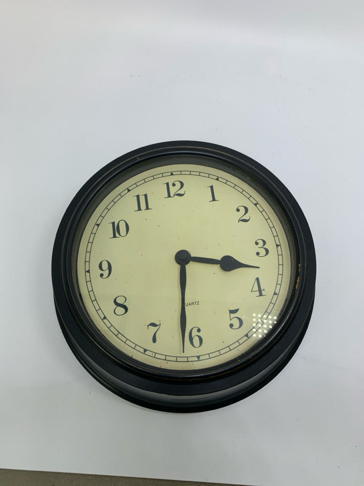 THICK BLACK PLASTIC WALL CLOCK.