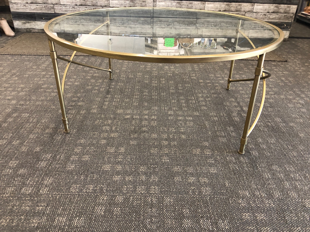 ROUND GLASS TOP COFFEE TABLE.