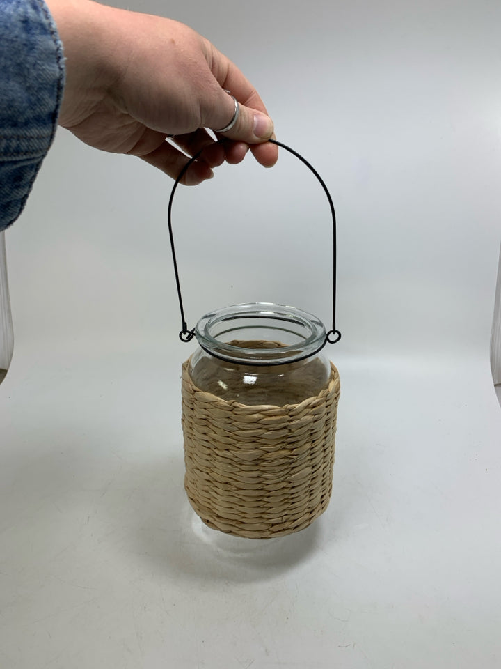 GLASS JAR W/ BASKET WOVEN OUTSIDE LANTERN.