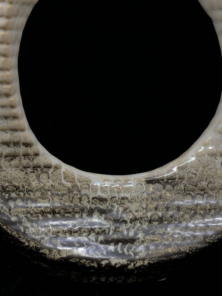 ABSTRACT CIRCULAR CUTOUT SCULPTURE CREAM AND BROWN.