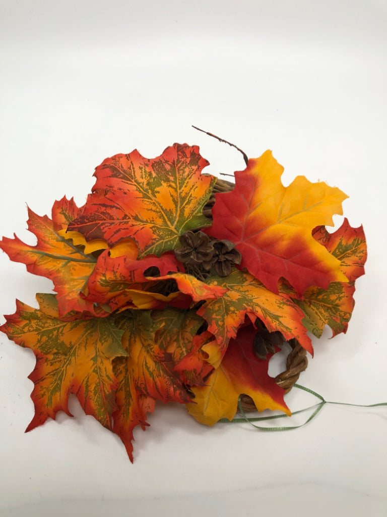 ORANGE LEAVES IN BROWN WICKER HANGING BASKET.