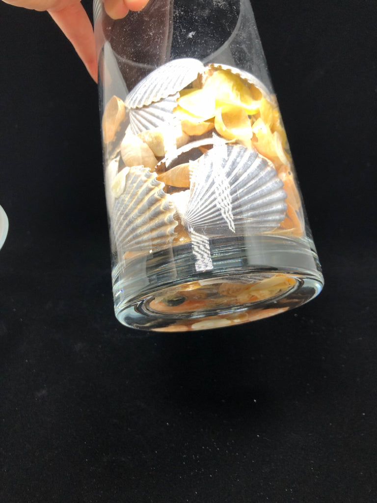 SEASHELL FILLED GLASS CANDLE HOLDER.