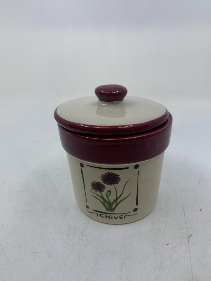 CHIVE CANISTER W/ CANDLE INSIDE.