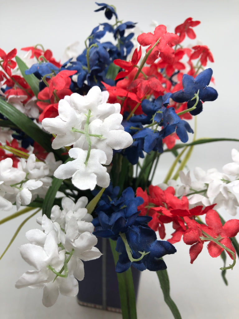 AMERICANA TIN W/ RED,WHITE,BLUE FAUX FLOWERS.
