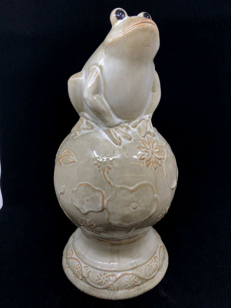 CREAM CERAMIC FROG ON SPHERE W/FLOWER DESIGN.