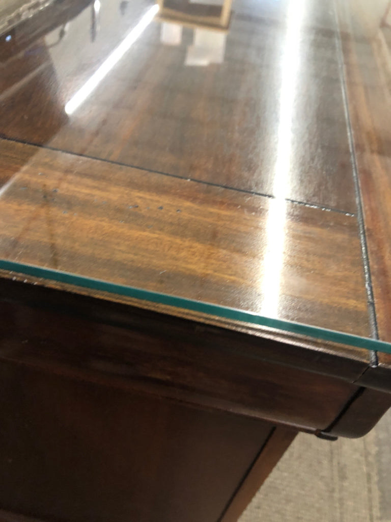 DARK CHERRY SIDE TABLE W/VTG METAL HANDLES & GLASS COVER ON WHEELS.