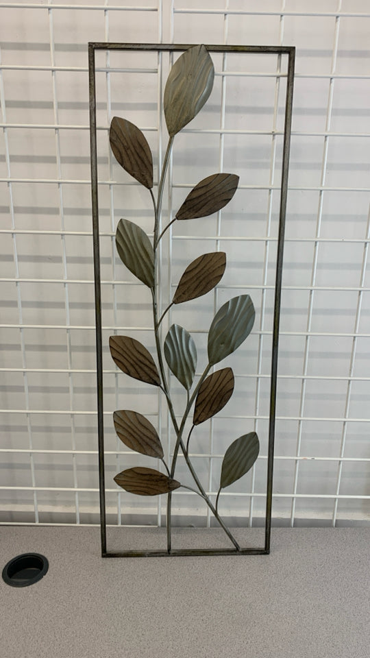 METAL LEAVES IN GREY METAL FRAME.