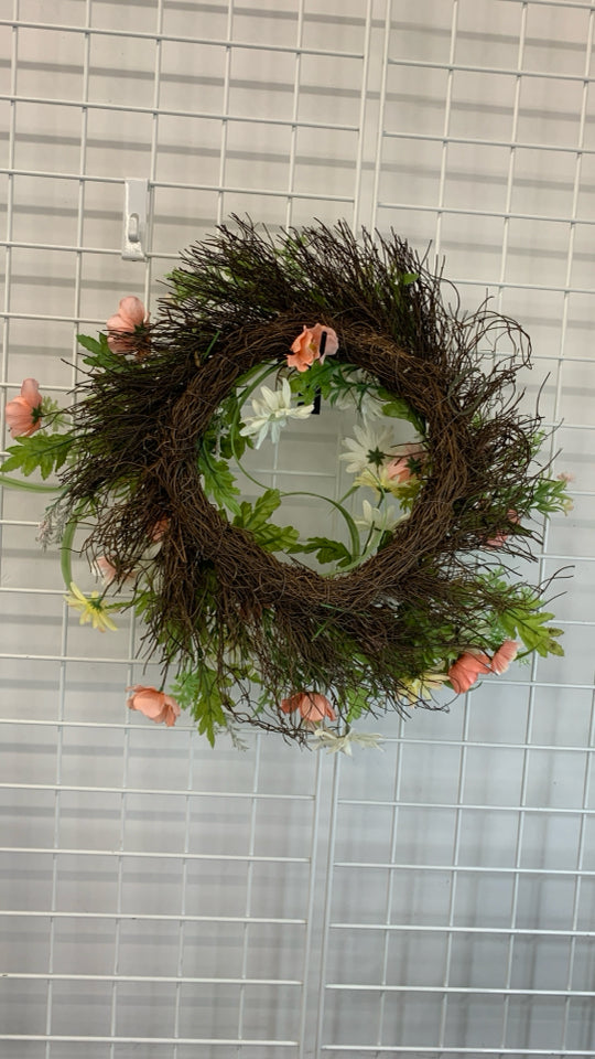 FAUX WILDFLOWER AND GREENS WREATH.
