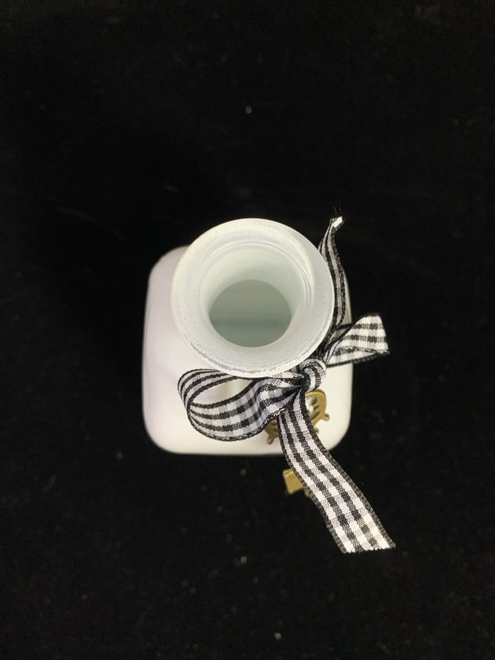 WHITE GLASS BOTTLE W/RIBBON AND KEY.