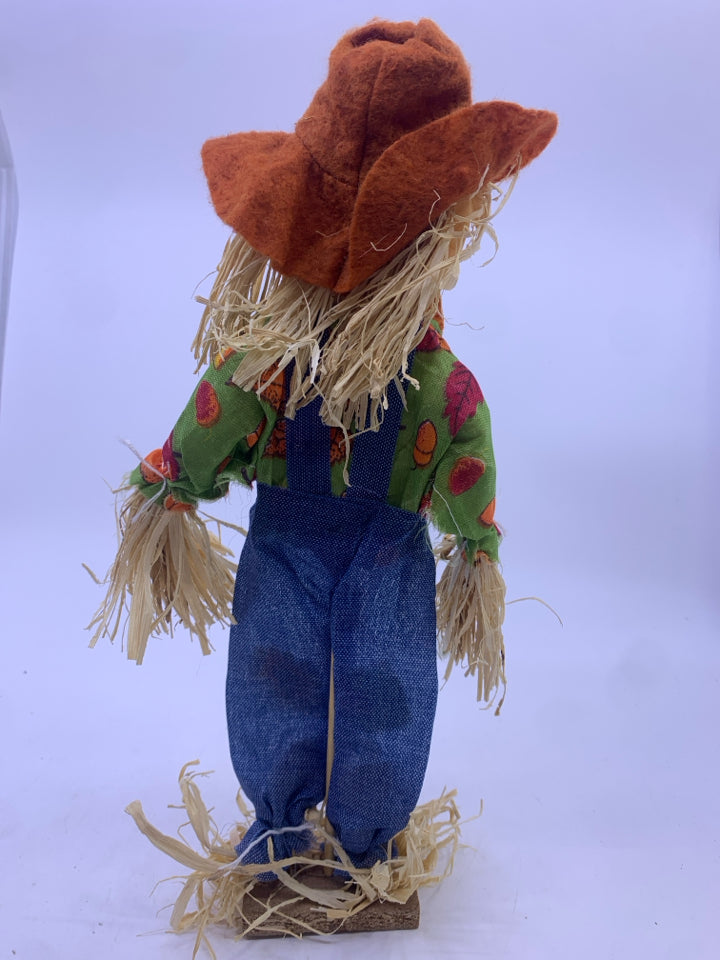 SCARECROW W/ WOOD STAND BLUE STRIPPED OVERALLS.