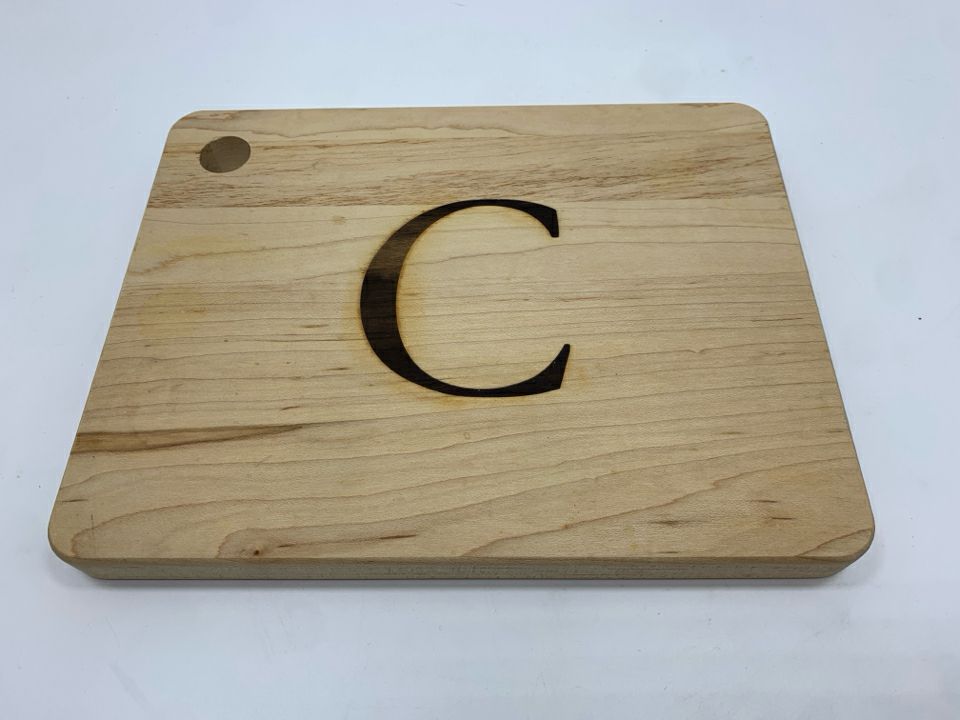 "C" WOODEN CUTTING BOARD.