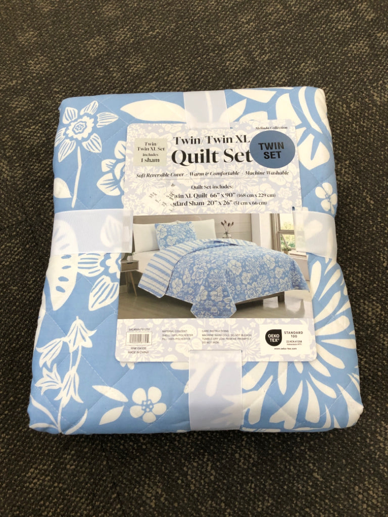 NIP REVERSIBLE BLUE FLORAL TWIN/ XL QUILT SET.
