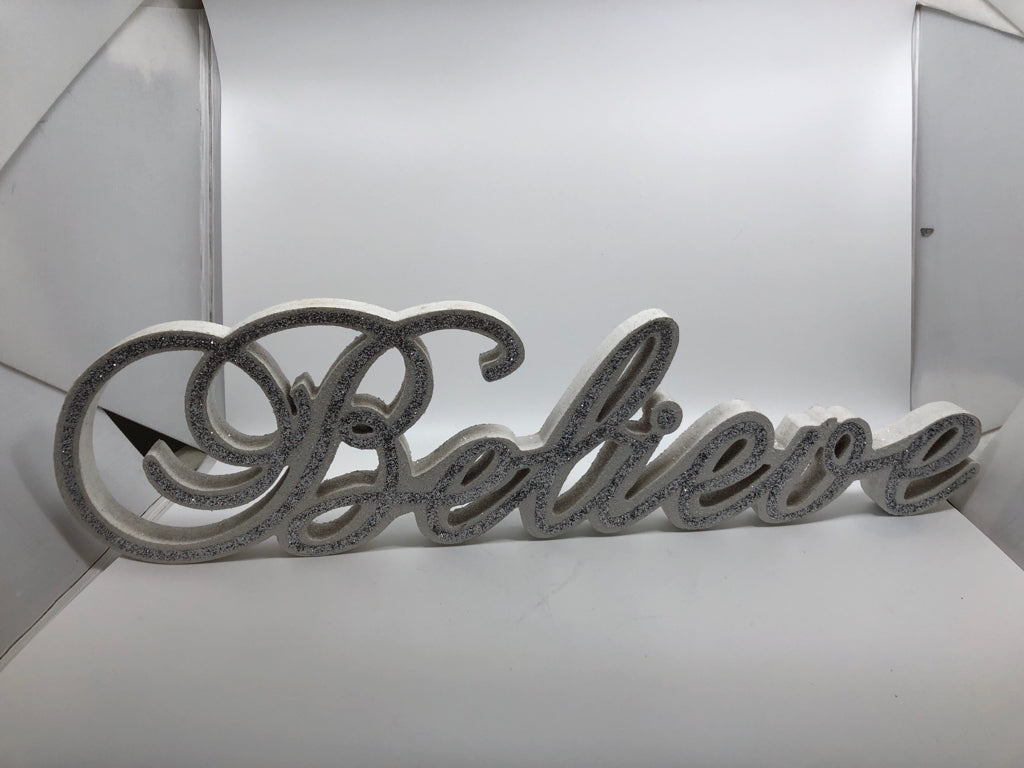 WHITE "BELIEVE" SILVER GLITTER SHELF SIGN.