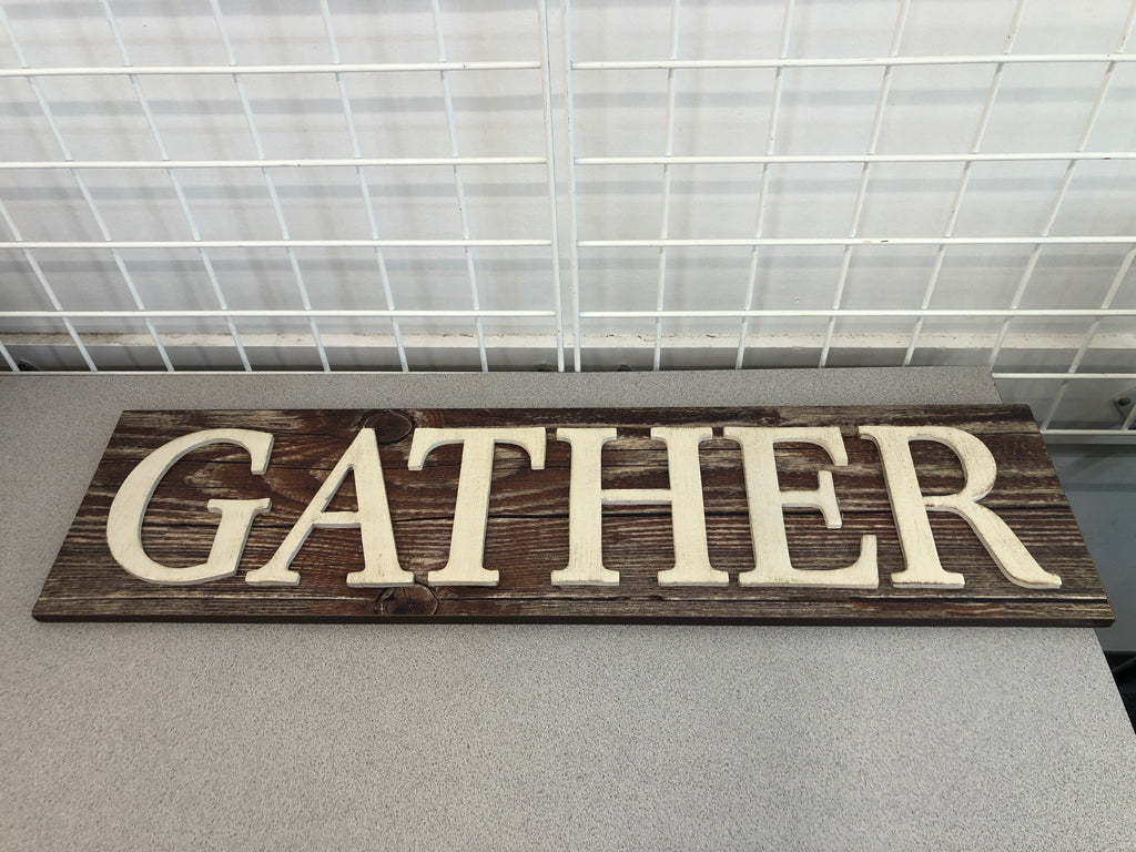 GATHER SIGN ON WOOD WALL HANGING.