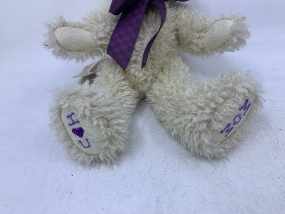 SCRUFFY WHITE BEAR W/ PURPLE BOW.