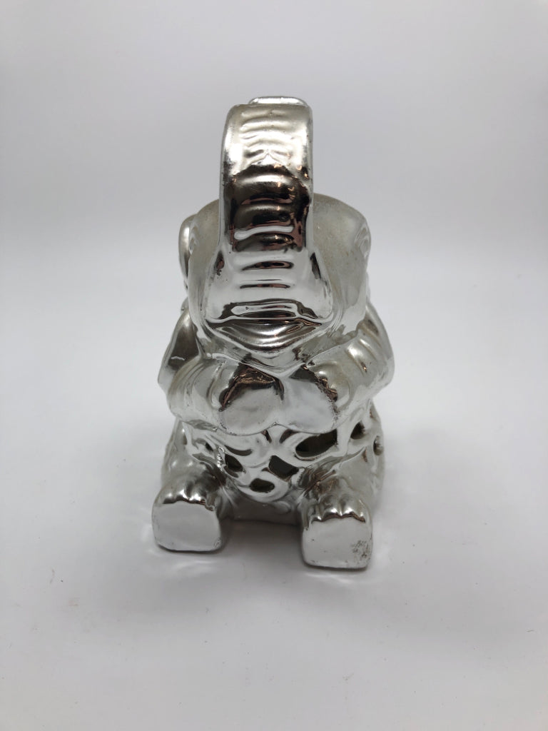 SILVER COLOR CERAMIC SITTING ELEPHANT.