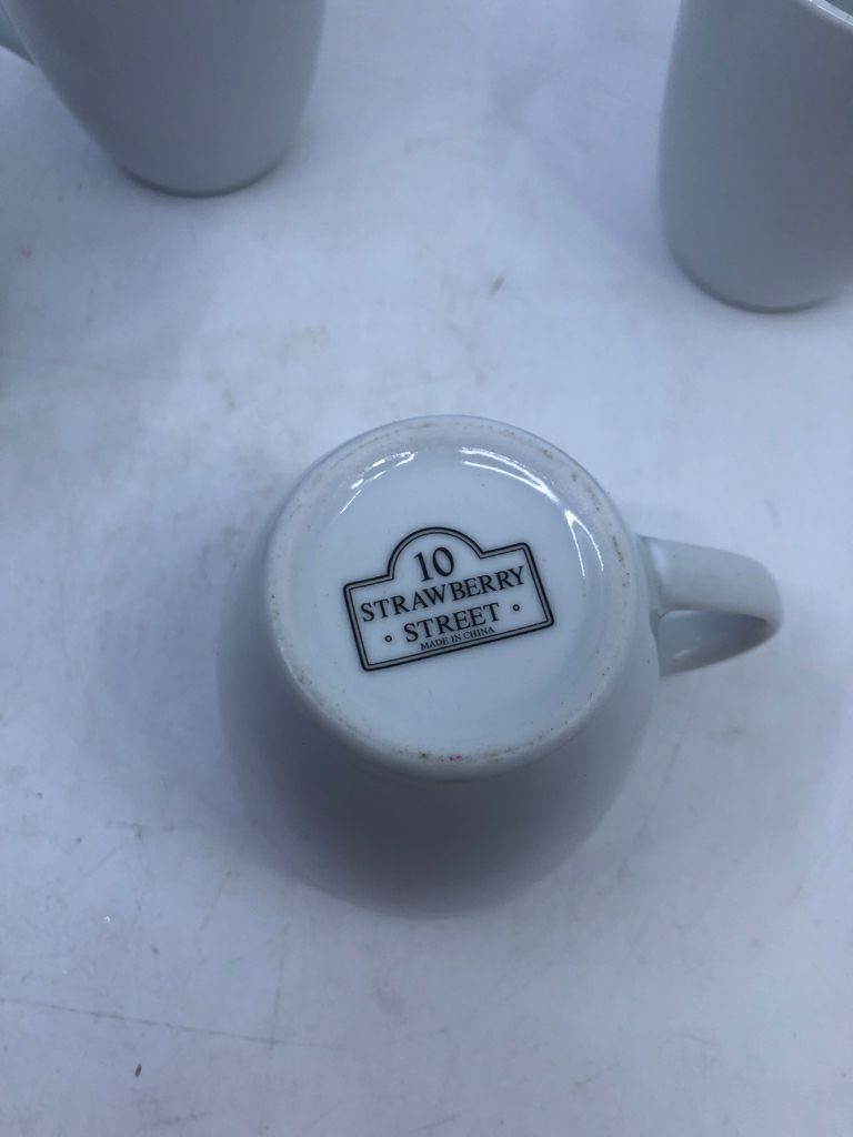 4 WHITE CERAMIC COFFEE MUGS.