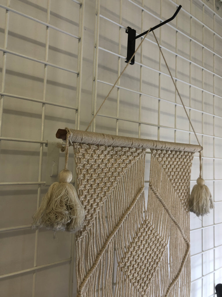 MACRAME WALL HANGING ON DOWEL W/ LARGE TASSELS.