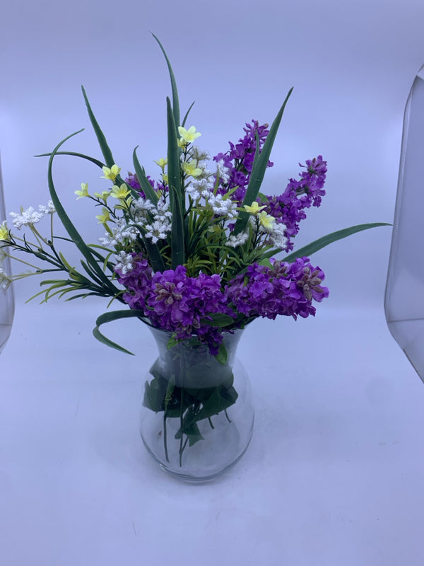 FAUX LAVENDER W/ YELLOW AND WHITE FLOWERS IN GLASS VASE.