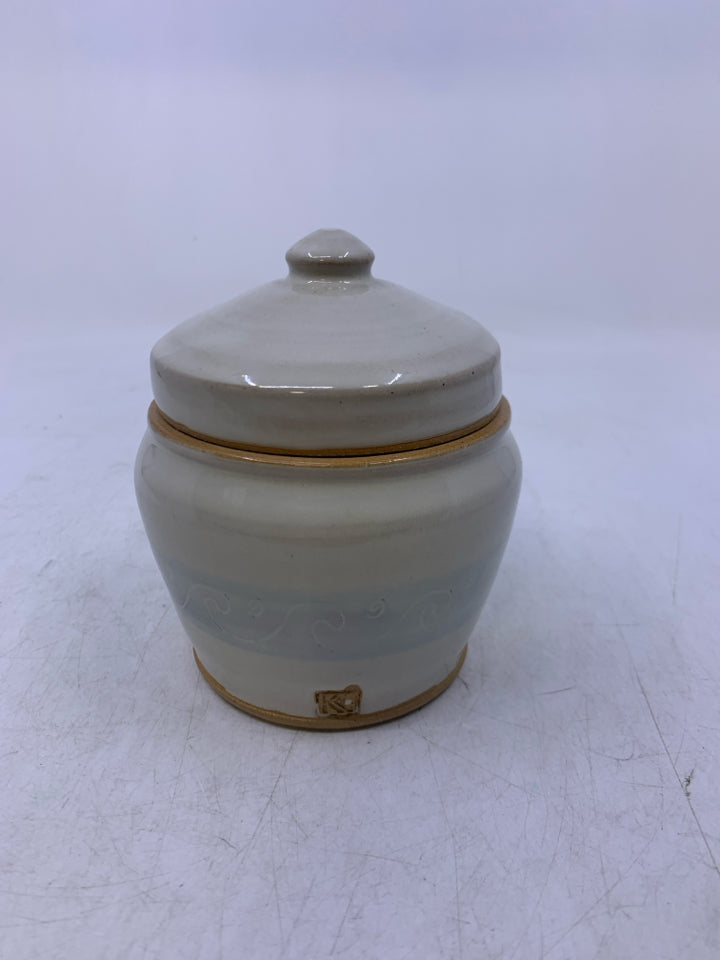 CREAM SHORT POTTERY CANISTER W/ LIGHT BLUE BAND WHITE WAVE OUTLINES.