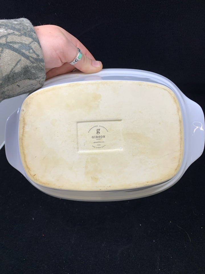 WHITE SMALL BAKING DISH IN BLACK METAL STAND.