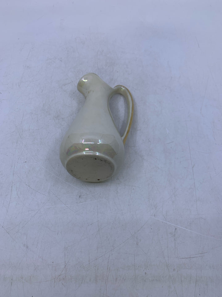 SMALL IVORY IRIDESCENT PITCHER W/ GOLD DETAILS.