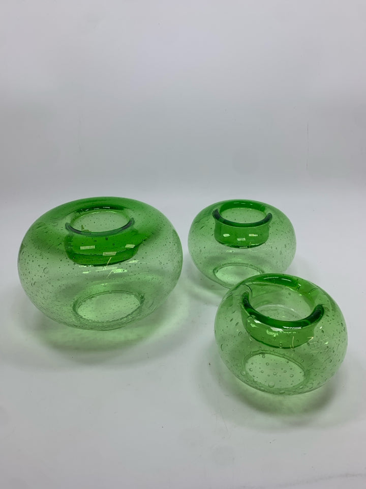 3 GREEN GLASS VOTIVE CANDLE HOLDERS.