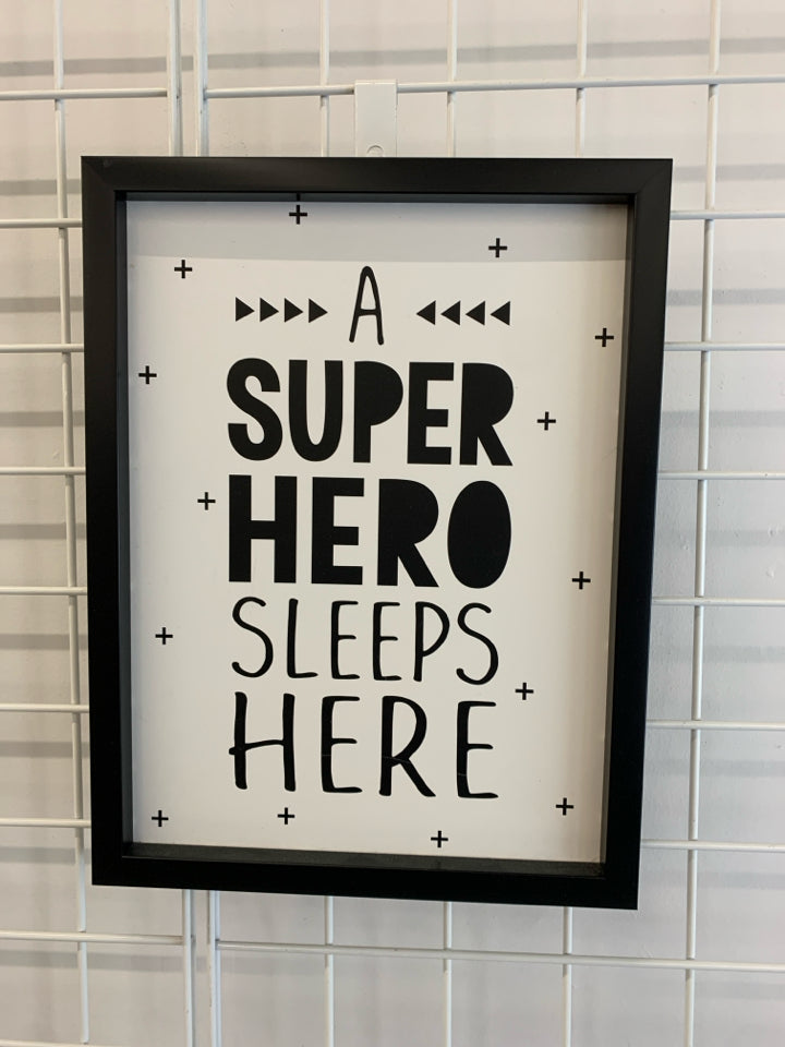 A SUPER HERO SLEEPS HERE WALL-HANGING.
