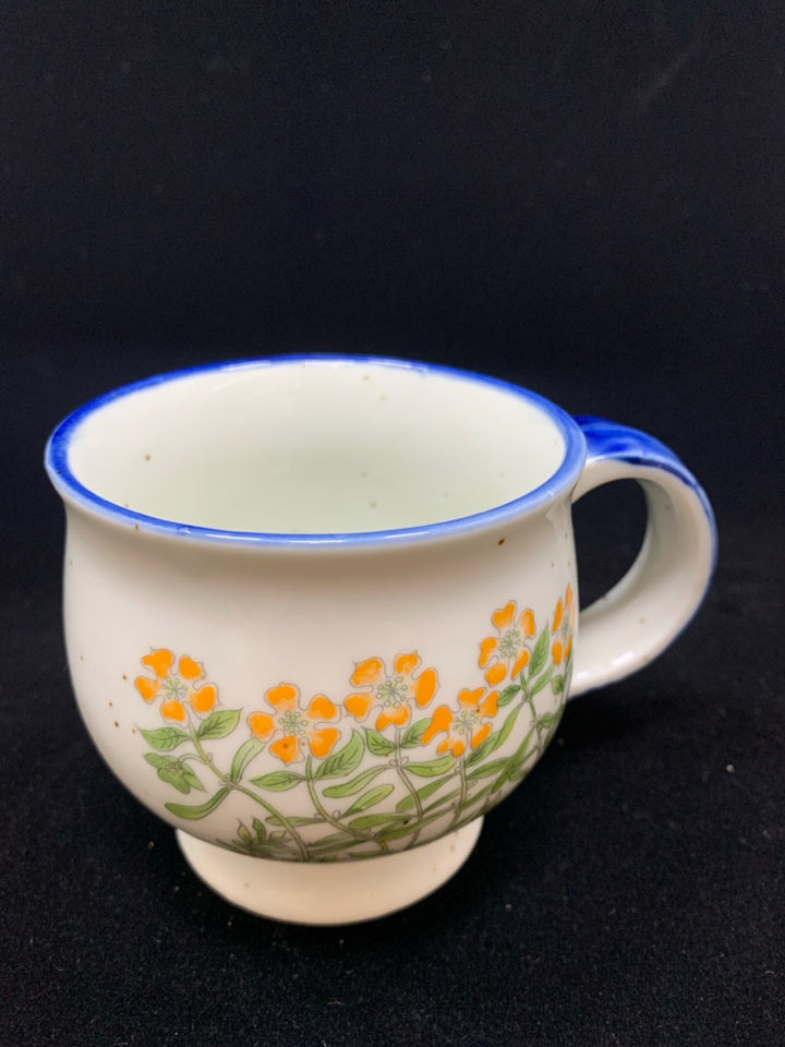 BLUE CERAMIC DOTTED MUG W/ORANGE FLOWERS.