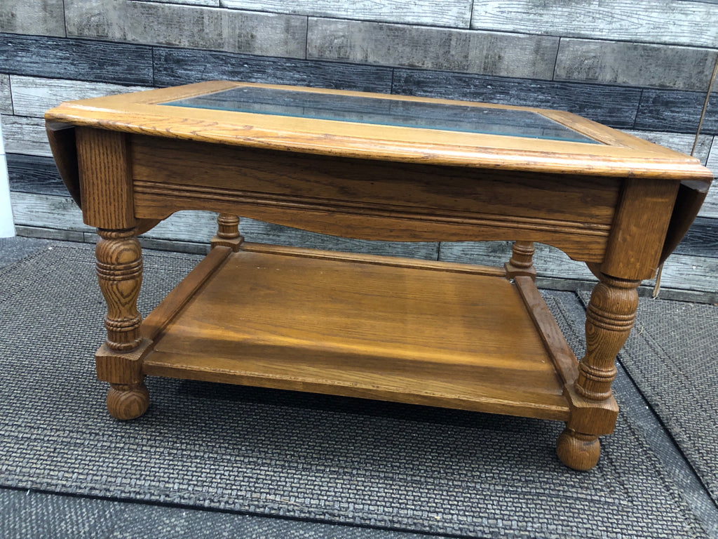 OAK WOOD COFFEE TABLE W/ GLASS TOP/FOLDING SIDES.