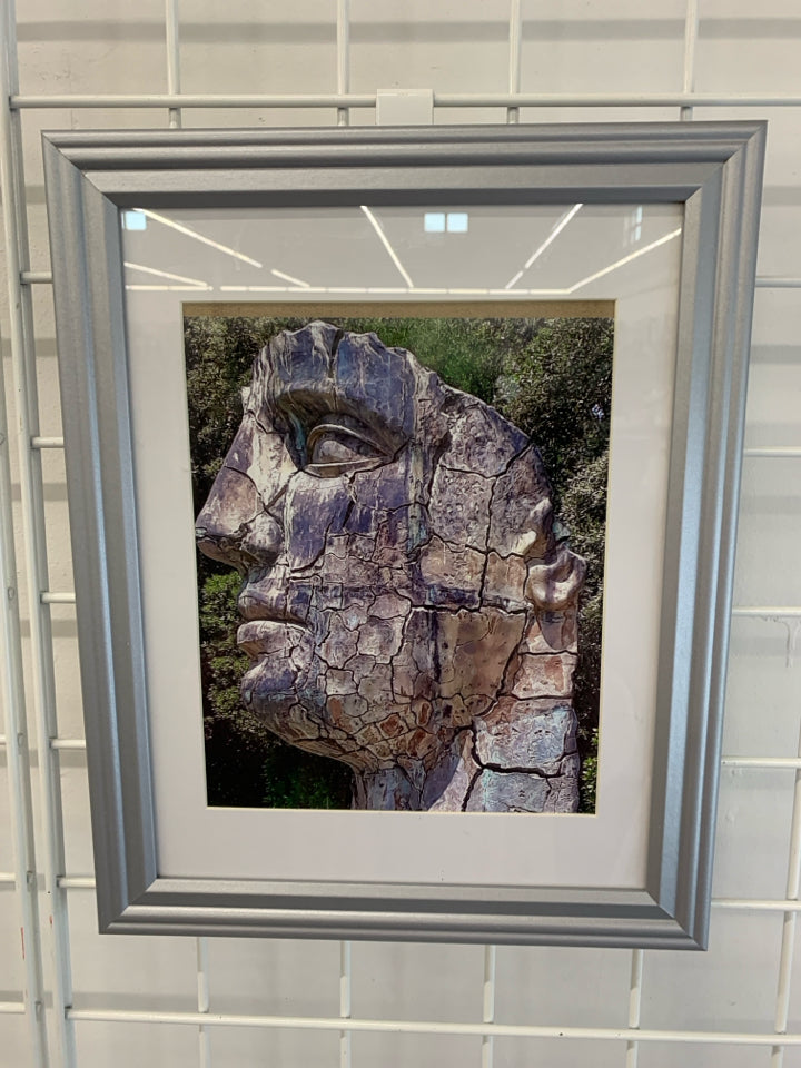 STONE FACE ON WHITE PRINT IN GRAY FRAME.