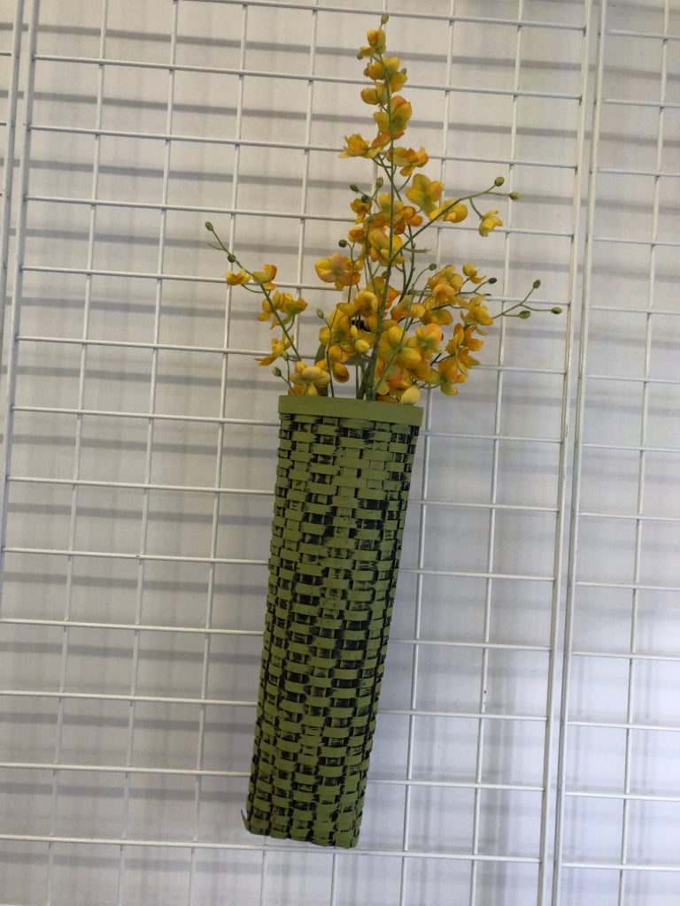 FAUX YELLOW FLOWERS IN GREEN WOVEN BASKET WALL HANGING.
