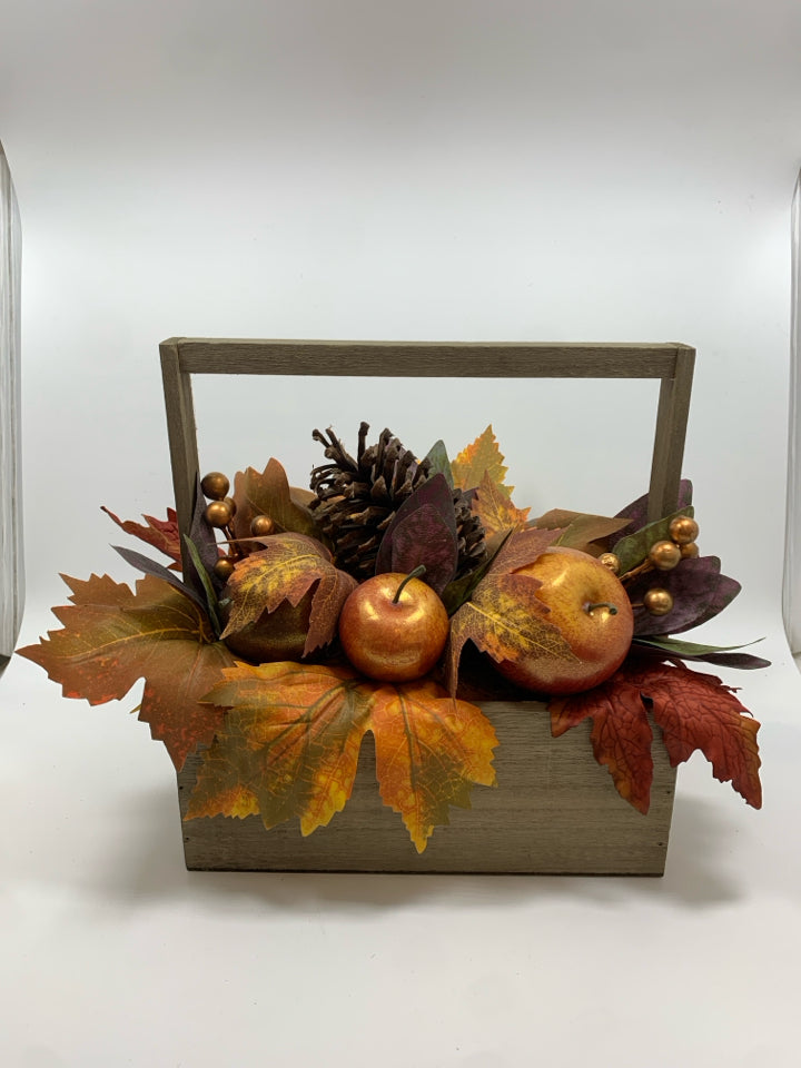 FAUX FALL FOLIAGE AND APPLES IN WOODEN BASKET.