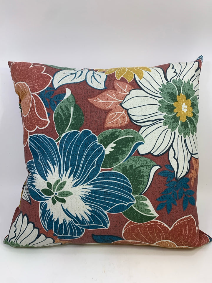 RED OUTDOOR PILLOW W/BLUE AND WHITE FLOWERS.
