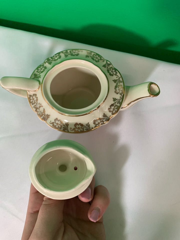 VTG CREAM AND GOLD TEAPOT.