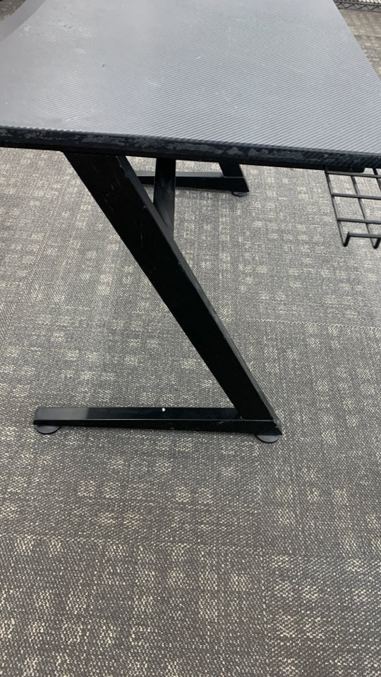 BLACK PLASTIC GAMING DESK W/ANGLED METAL LEGS.