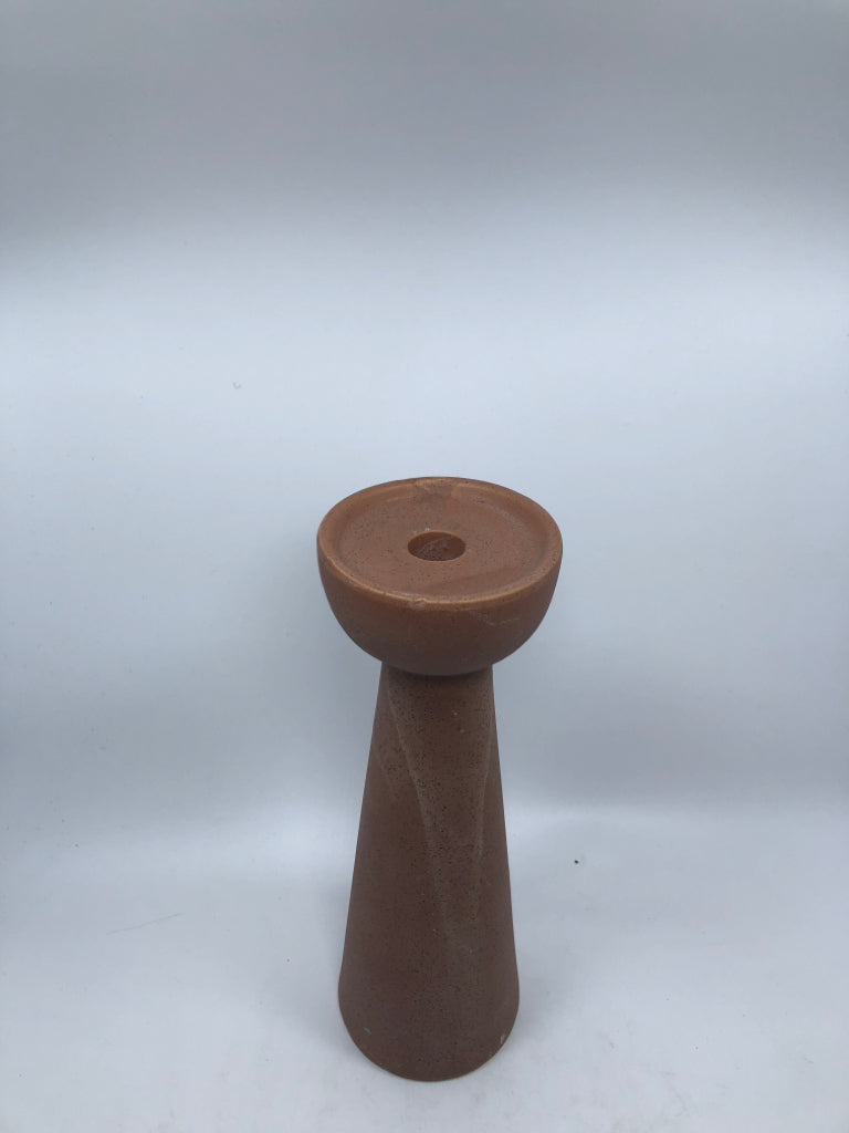 PINK STONE-STYLE CANDLE STICK HOLDER.