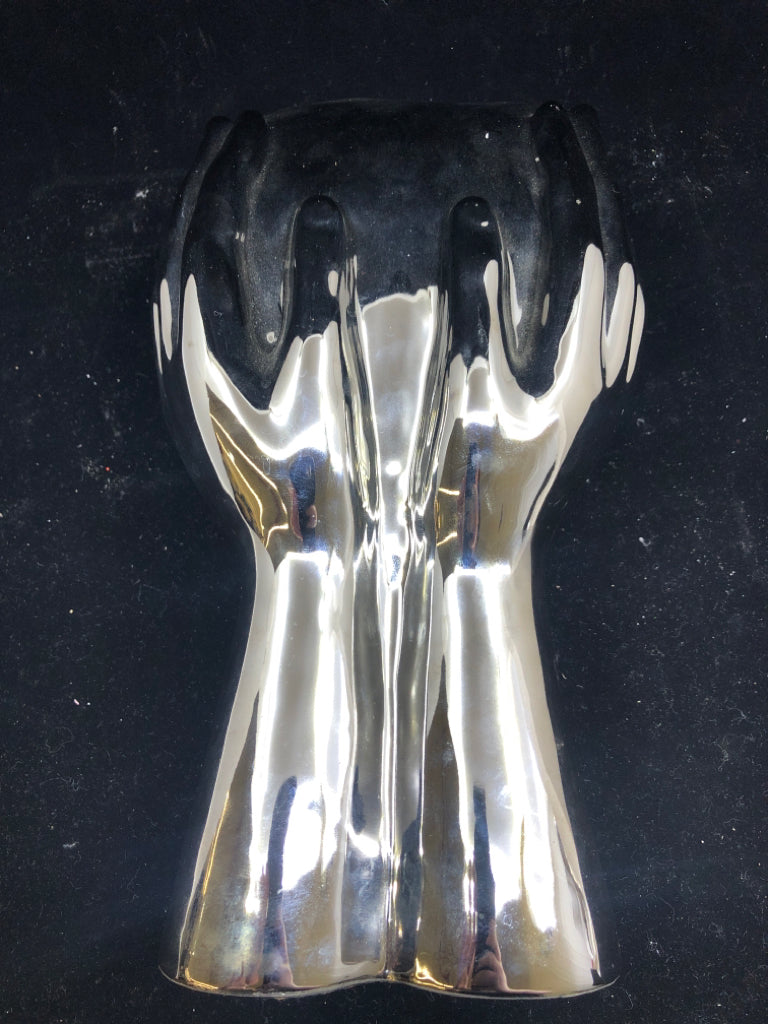 CERAMIC SILVER PERSON HOLDING UP THEIR FACE.