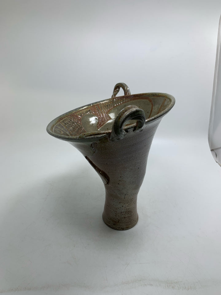 ABSTRACT VASE W/ CARVING INSIDE FLARED TOP AND SMALL HANDLES.
