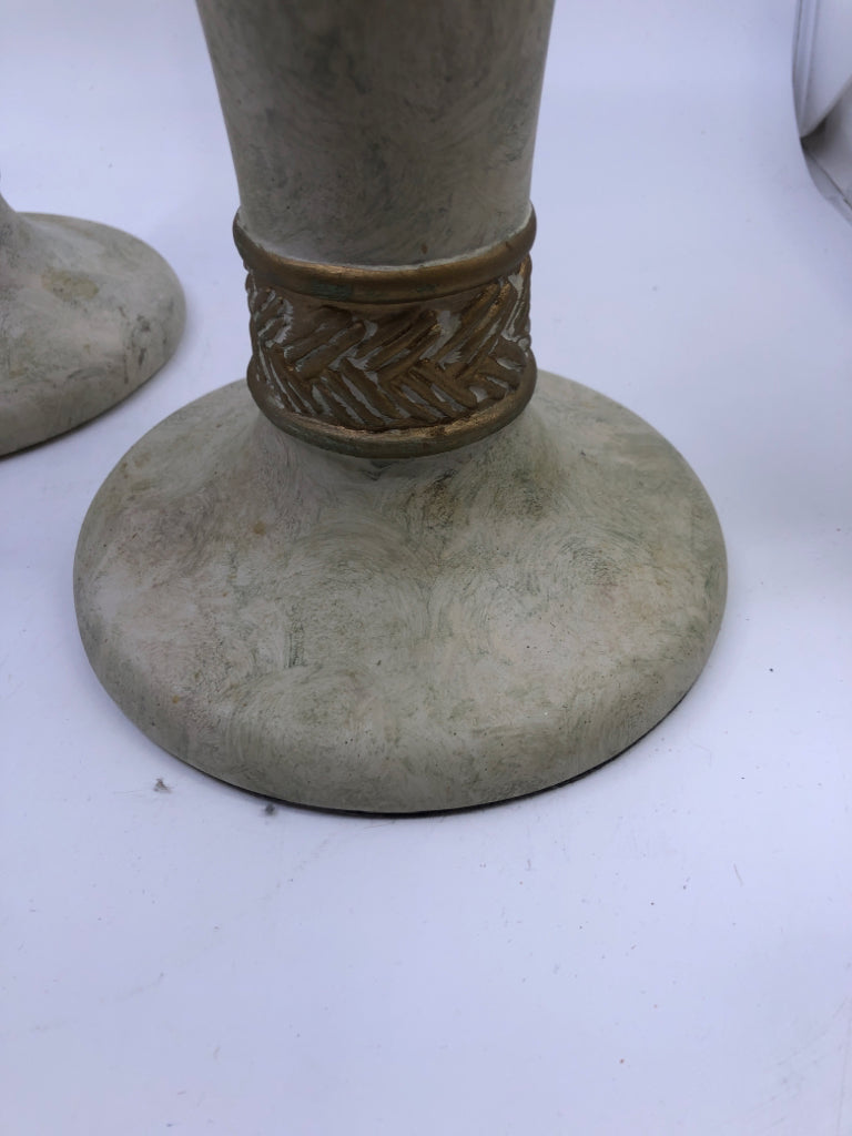 2 WHITE STONE W/GOLD DETAIL PILLAR CANDLE HOLDERS.