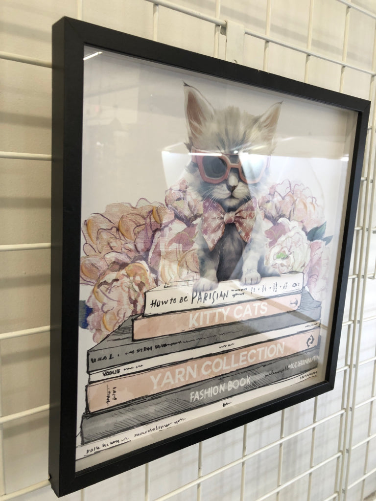 WHITE KITTY CAT IN PINK SUNGLASSES IN BLACK FRAME.