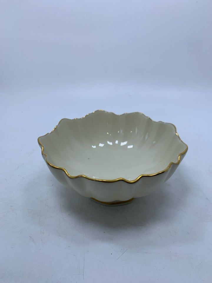 PORCELAIN FOOTED CANDY BOWL W/ UNEVEN EDGE.